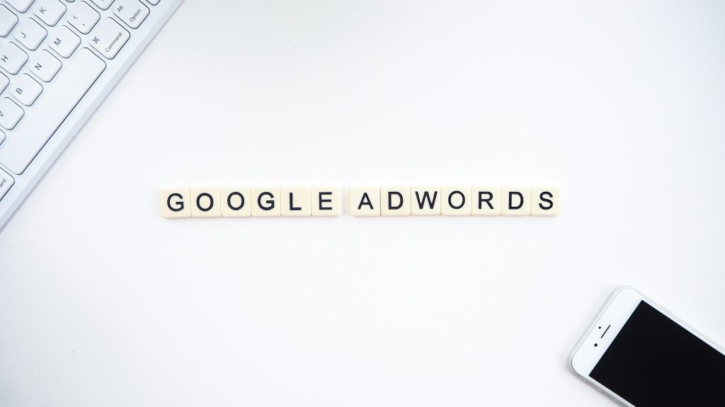 google adwords text tile on desk with keyboard and mobile phone